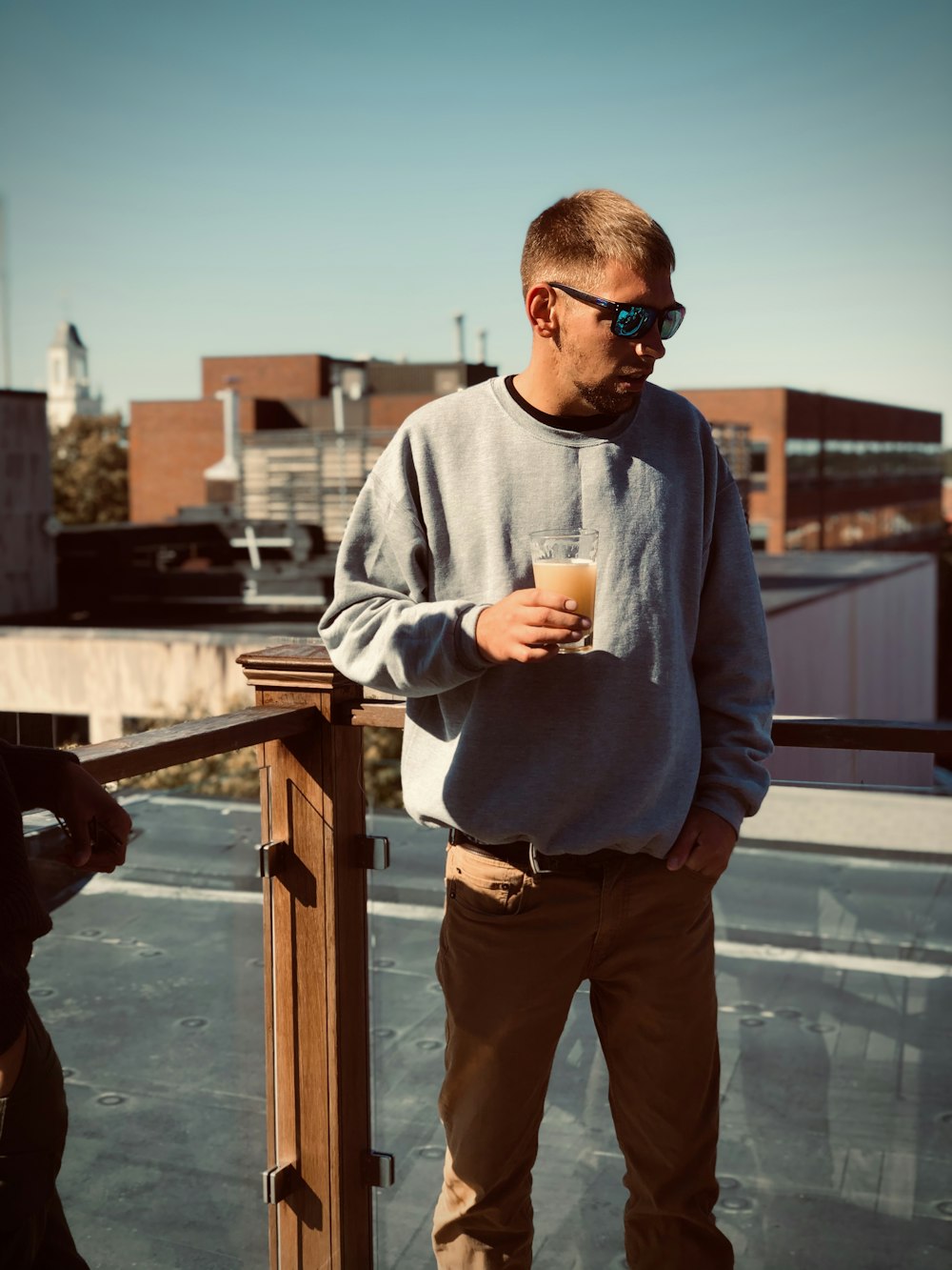 man standing and holding drink