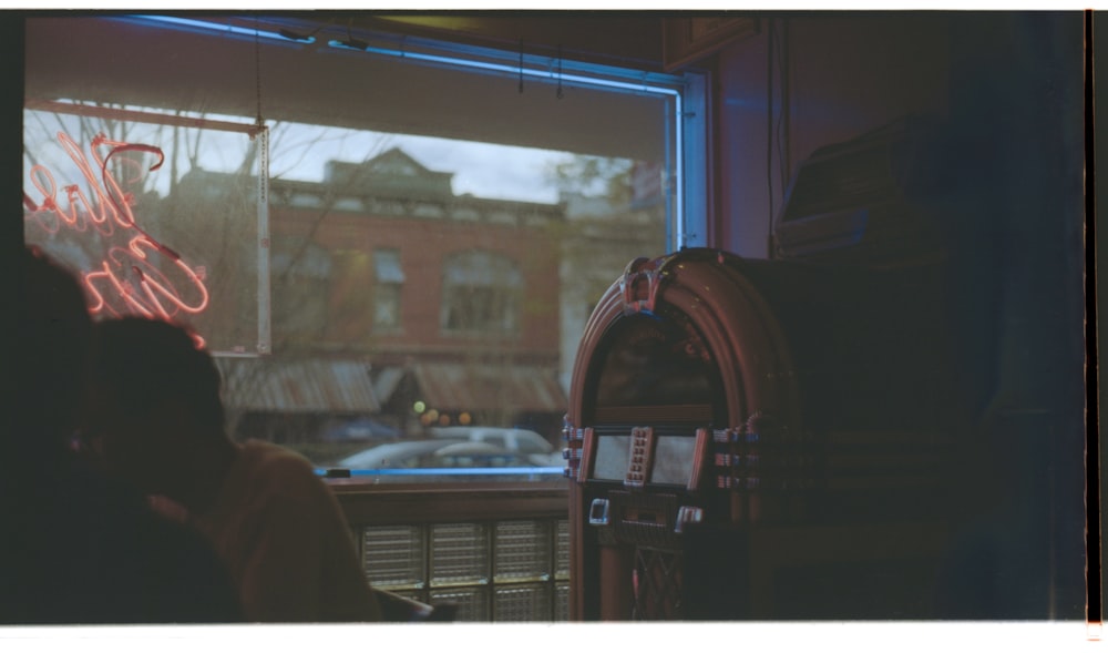 jukebox beside person indoors