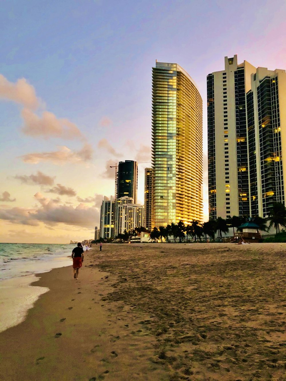 man walking along seashore during daytime