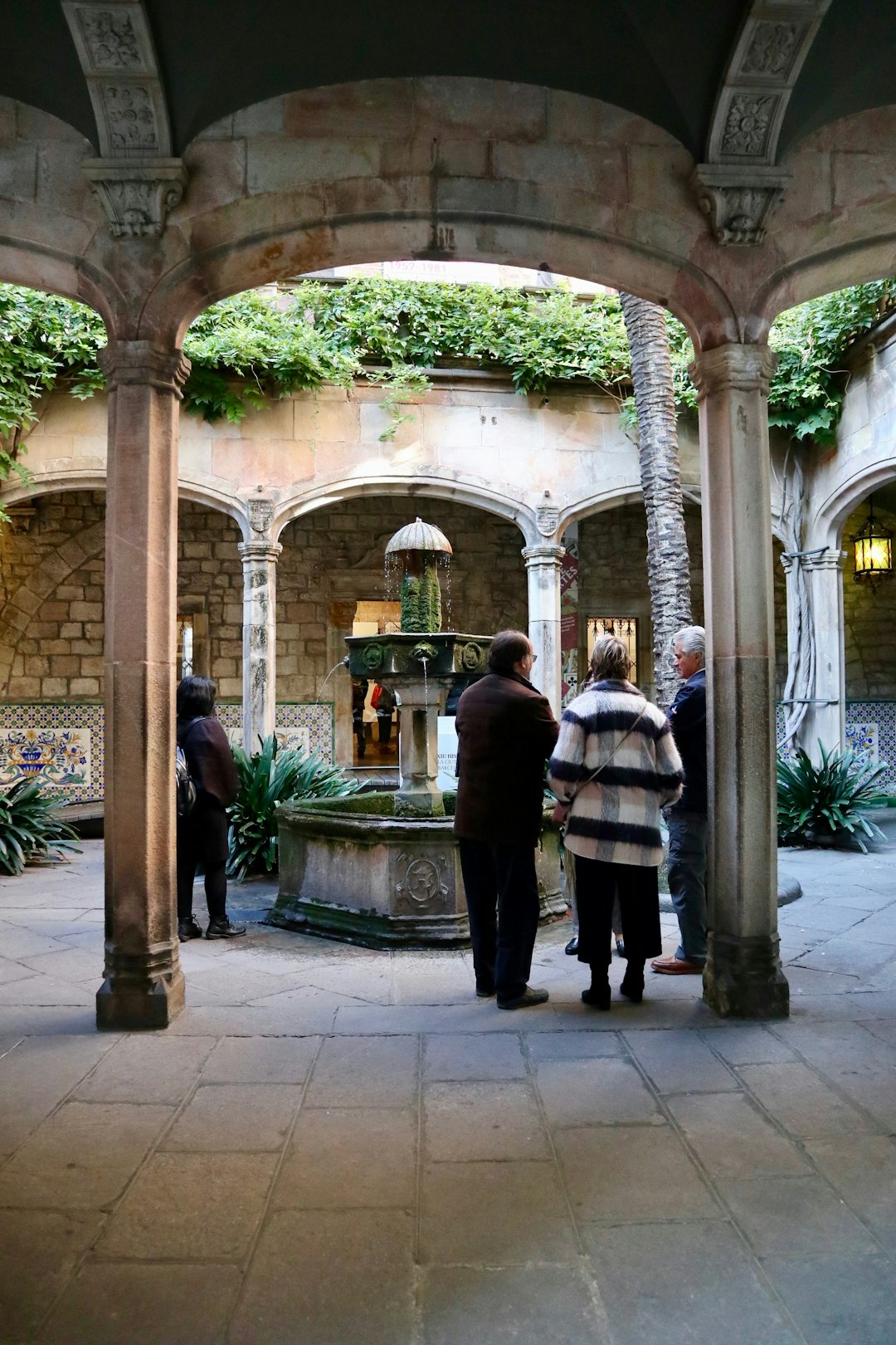  three people standing in a courtyard courtyard forecourt