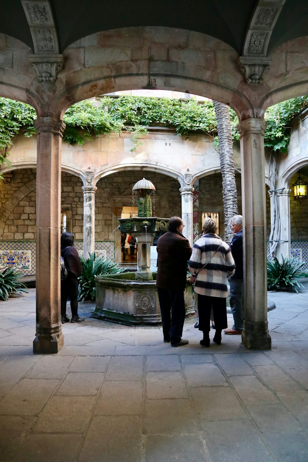 three people standing in a courtyard