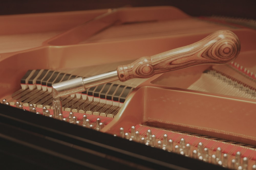 a close up of a piano with a metal handle