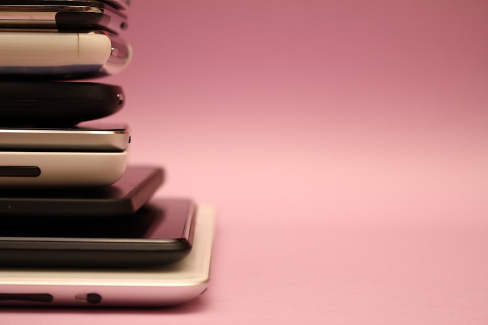 shallow focus photo of stacked up phones