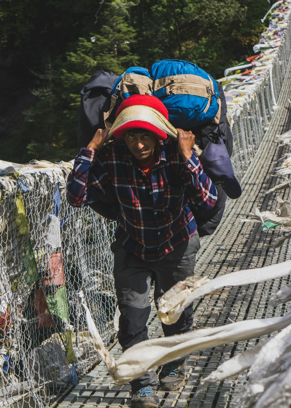 shallow focus photo of man carrying blue bag