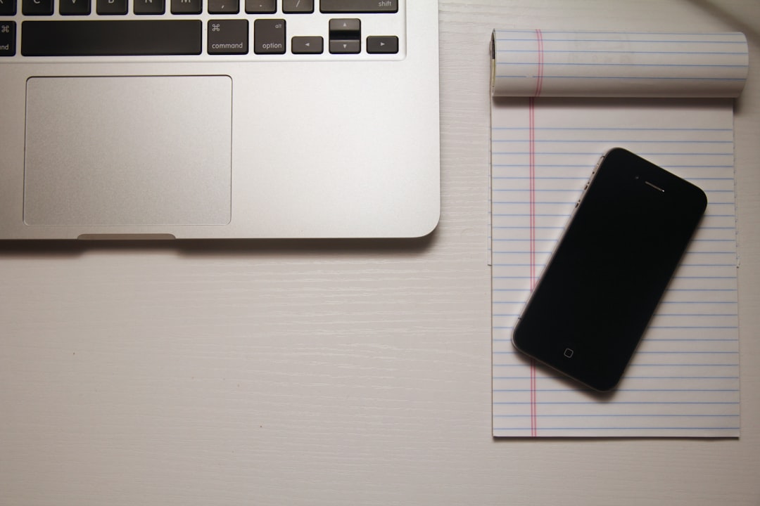 black iPhone 5 on white ruled paper sheet