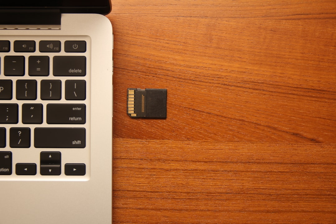 black micro-SD card beside gray laptop computer