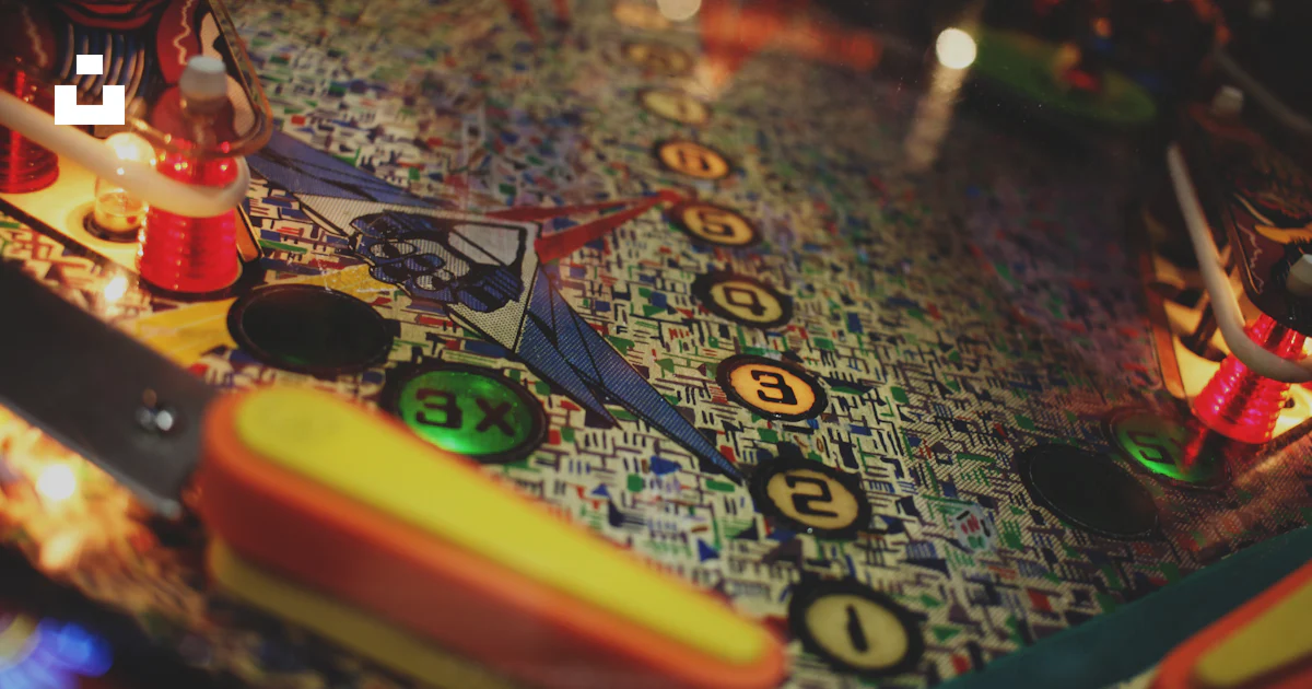 A close up of a pinball machine with a lit candle photo – Free Portrait ...