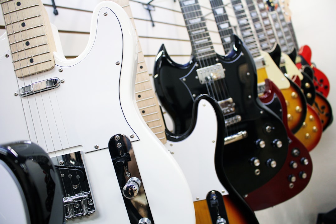 assorted-color electric guitars