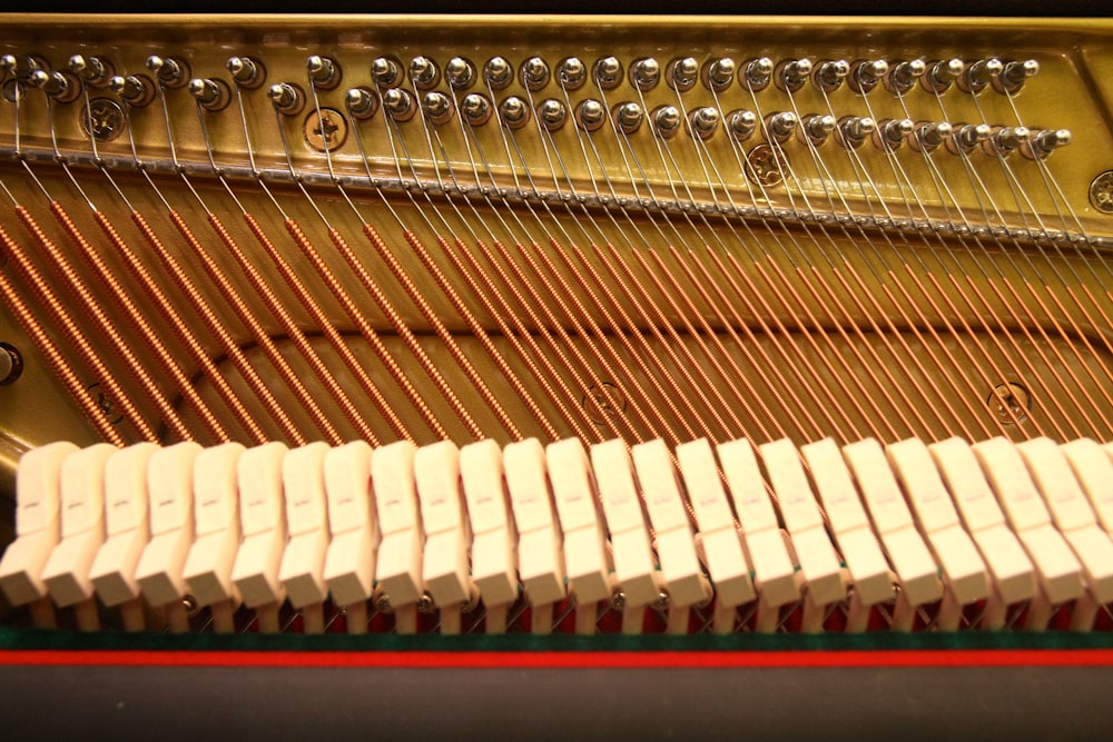 a close up of a piano with strings