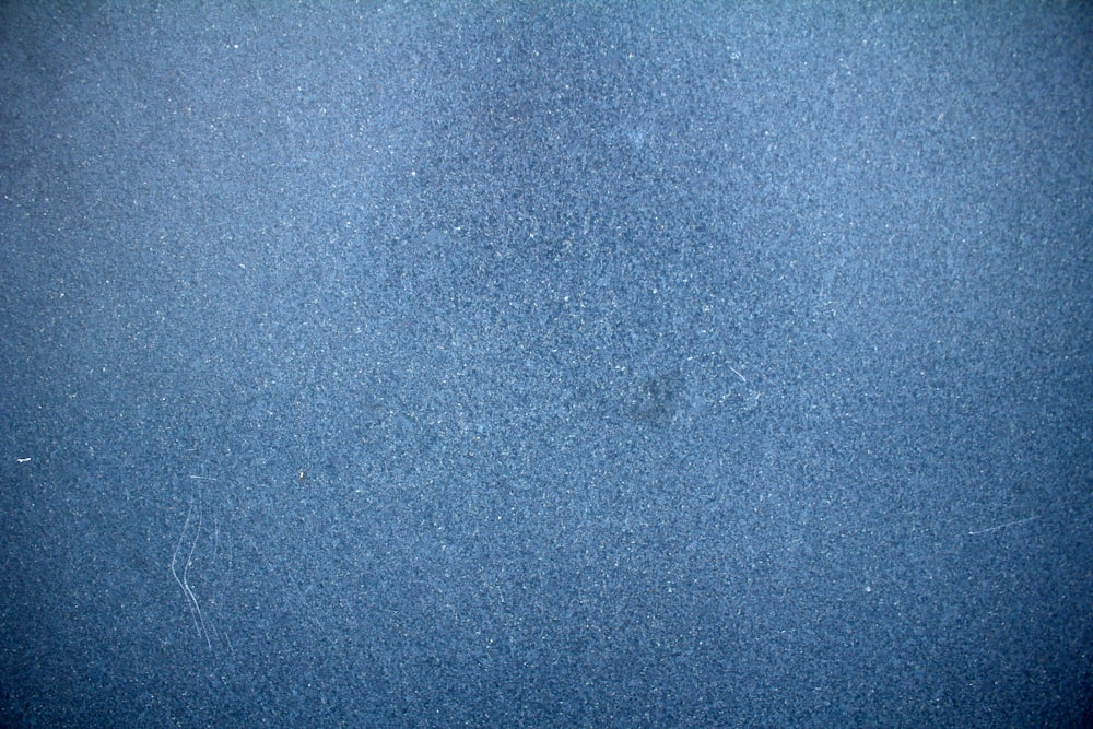 a close up of a blue surface with a black border