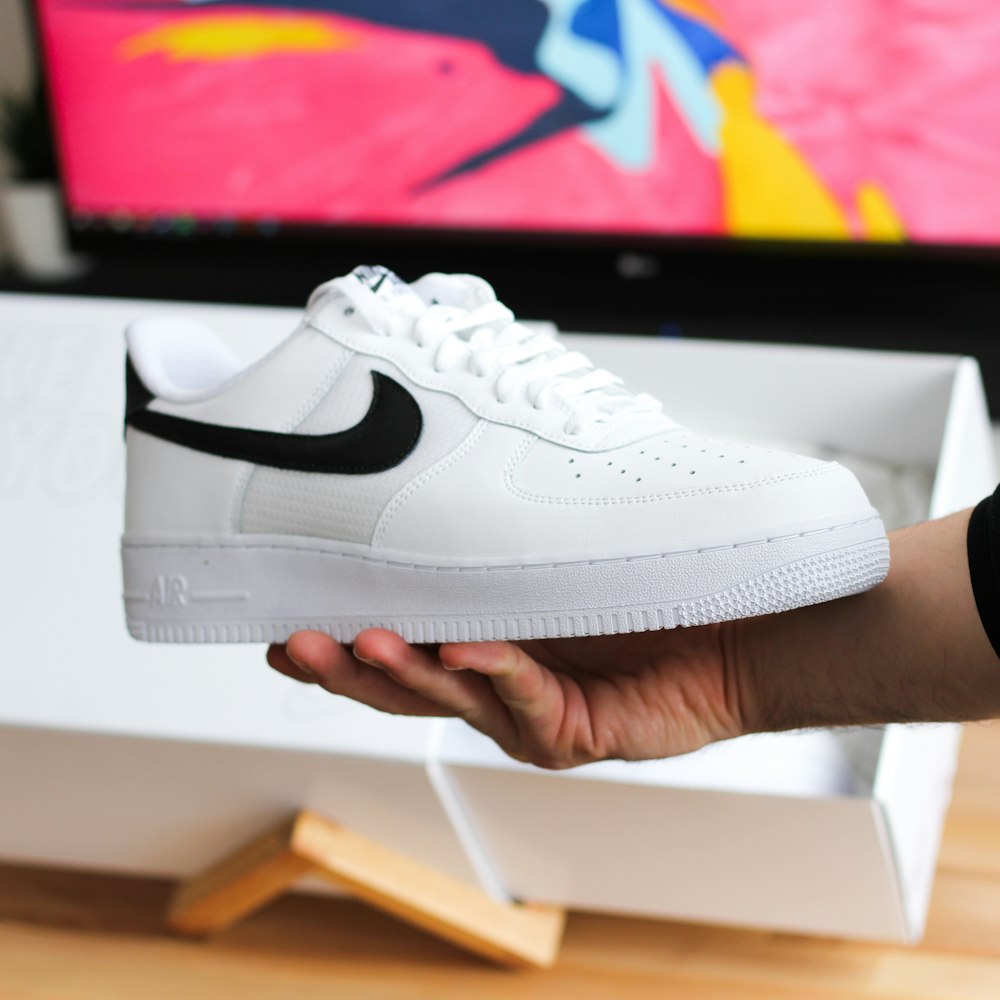 unpaired white and black Nike Air Force 1 low-top shoe