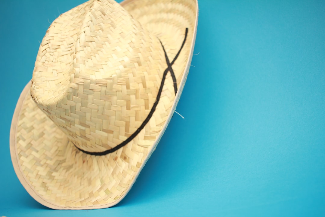 brown wicker hat on blue surface