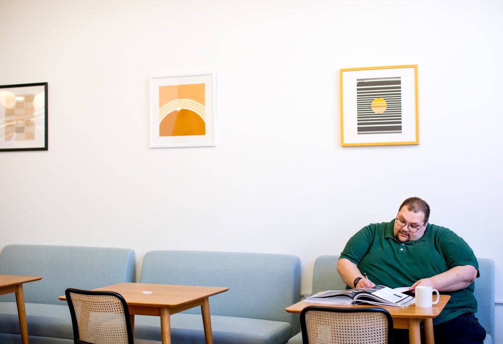 man sitting on sofa wrting on paper