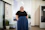 Professional businesswoman smiling confidently in a modern office environment.