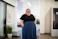 Smiling woman in business attire standing in a freshly cleaned modern office.