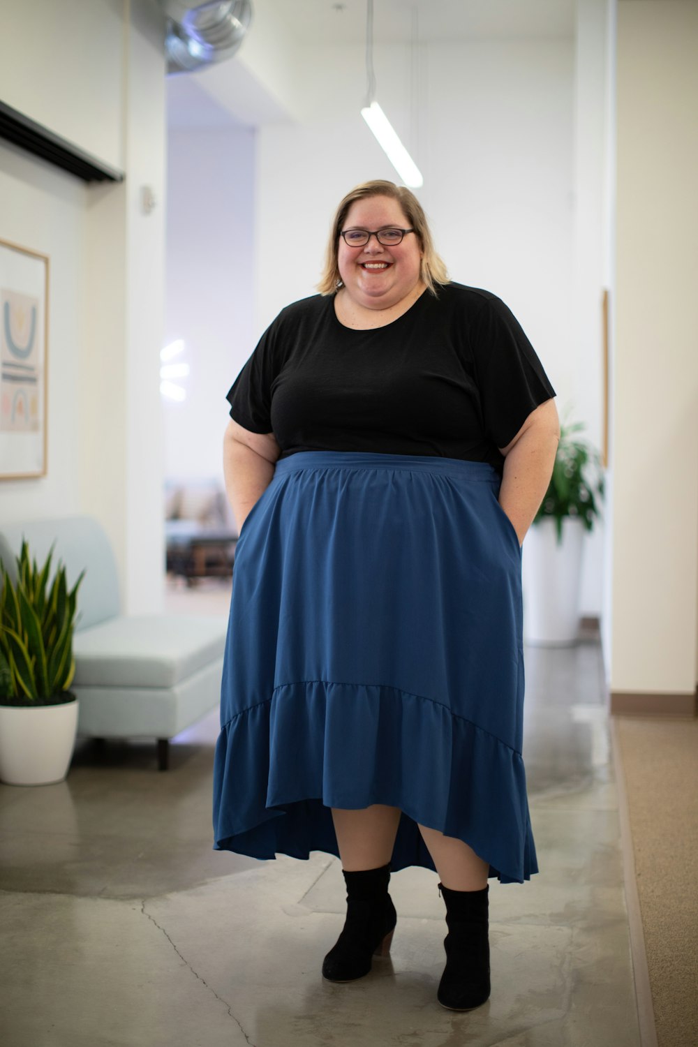 photography of smiling woman standing inside room