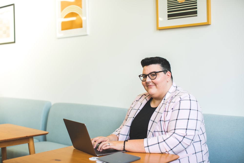 woman sitting down in front of a laptop computer