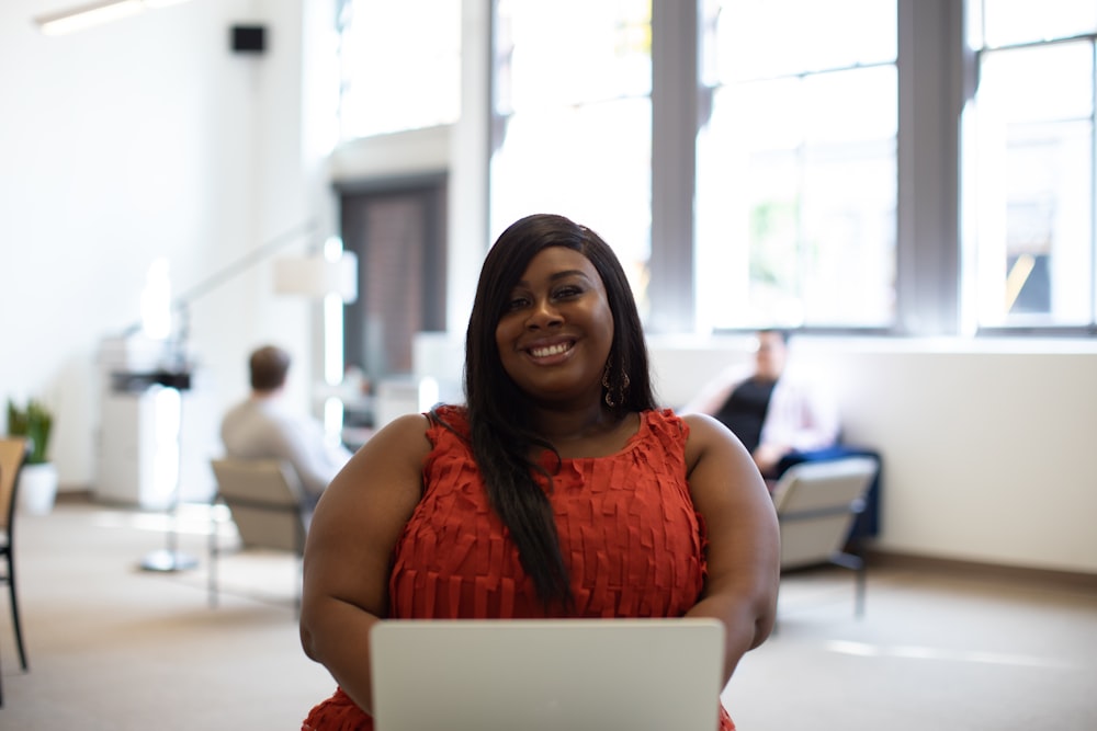 shallow focus photo of woman in red sleeveless shirt