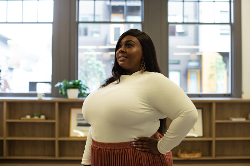 woman in a white long-sleeved shirt inside a building