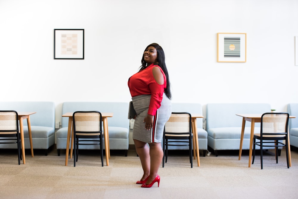 woman in red top and gray skirt