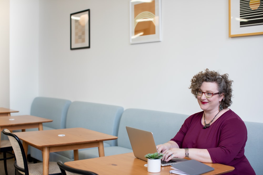 smirking woman using laptop computer