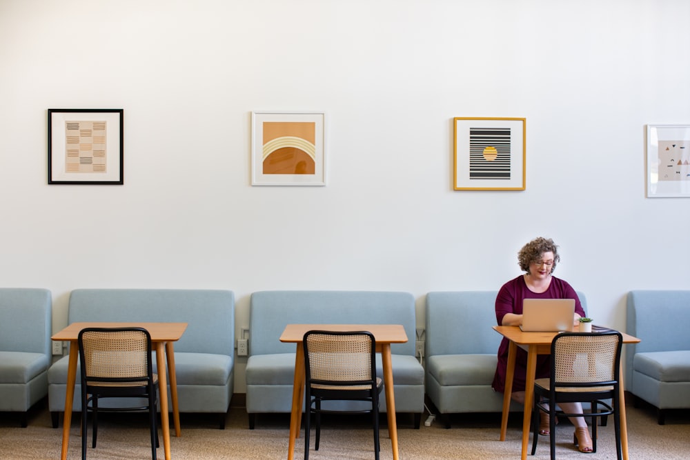 woman sitting on sofa near tables inside room