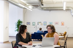 women talking around table