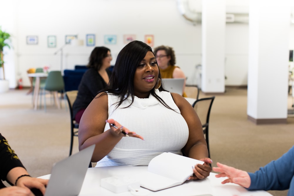 shallow focus photo of woman in white sleeveless shirt