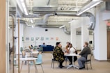 A group of diverse professionals discussing HVAC solutions in an office.