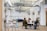 A diverse group of people discussing insurance options around a table in a bright office.