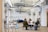A diverse group of architects discussing design plans around a large table in a bright office.