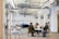 An architect discussing plans with clients at a modern office space.