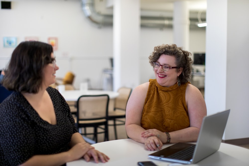 two women sitting indoors