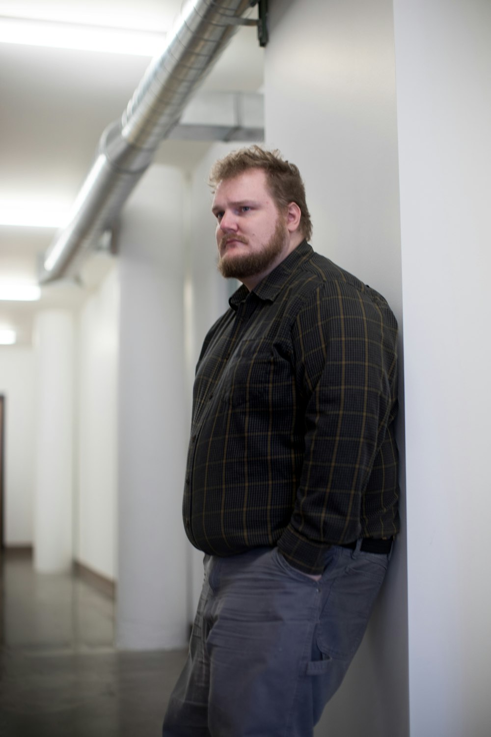 man leaning on wall