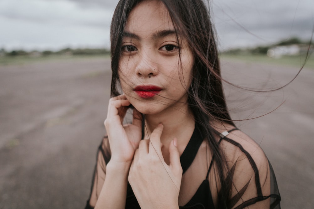 shallow focus photo of woman in black sheer top