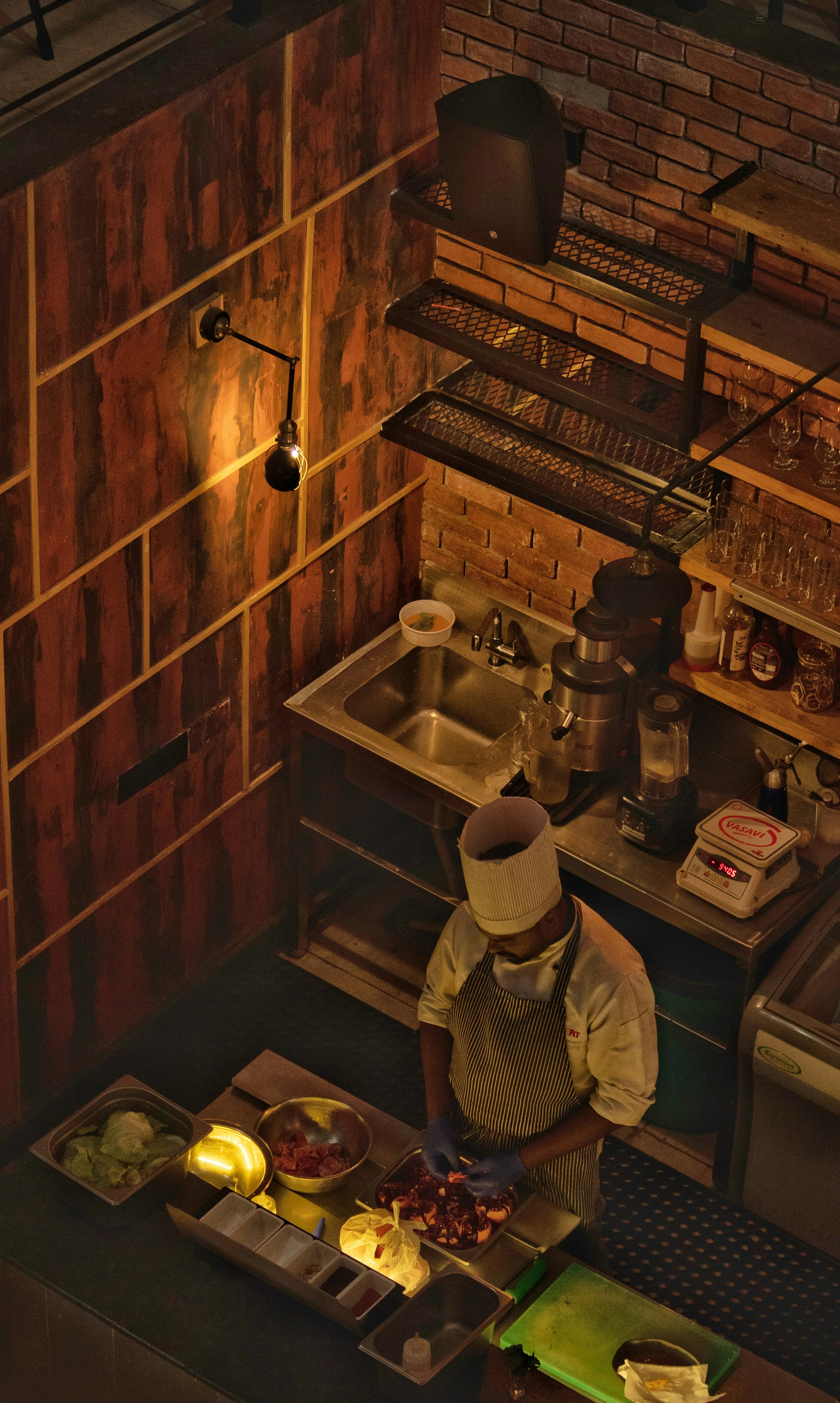 aerial photography of a man cutting ingredients in the kitchen