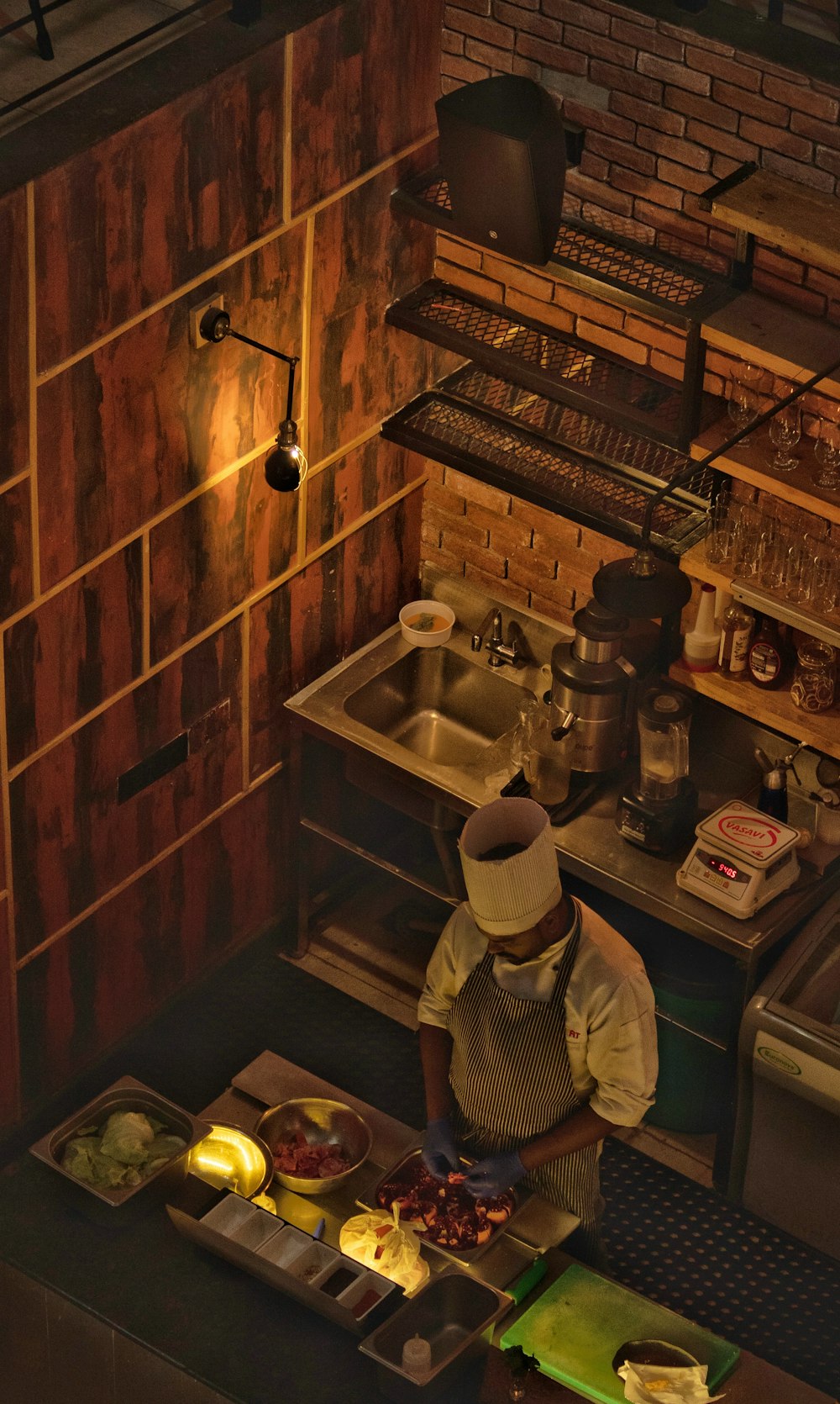 aerial photography of a man cutting ingredients in the kitchen