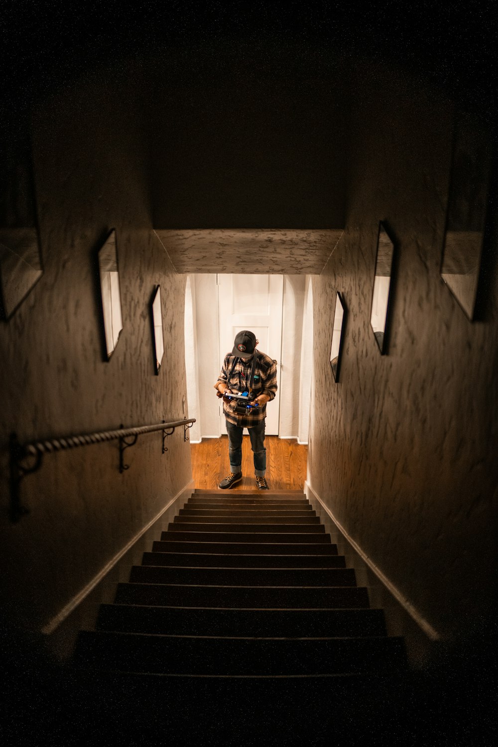 man standing at the bottom of a staircase