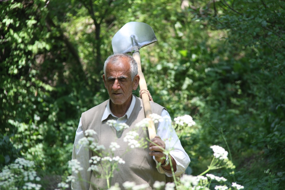 man with shovel in forest