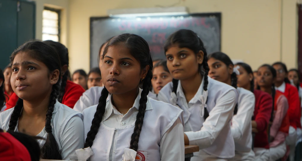 A vibrant classroom in Durgapur filled with attentive students and a passionate teacher engaging them in lively discussion.