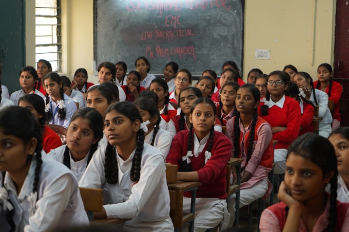 Students in red and white uniforms in a classroom setting, emphasizing academic pathways post-12th 