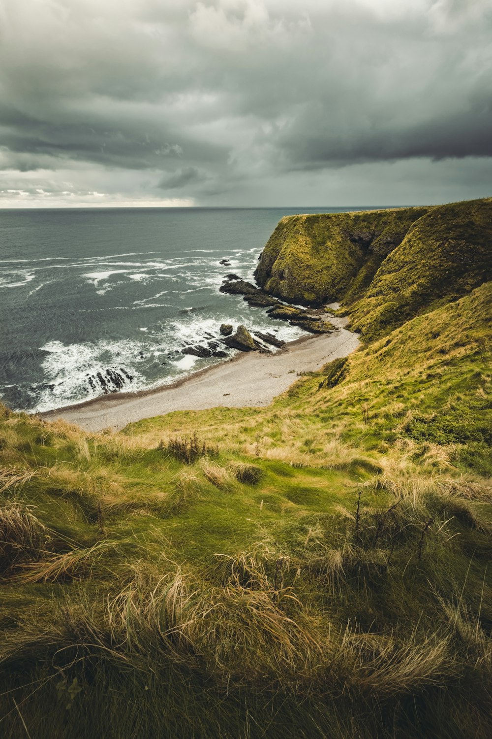 photography of mountain range and seashore during daytime