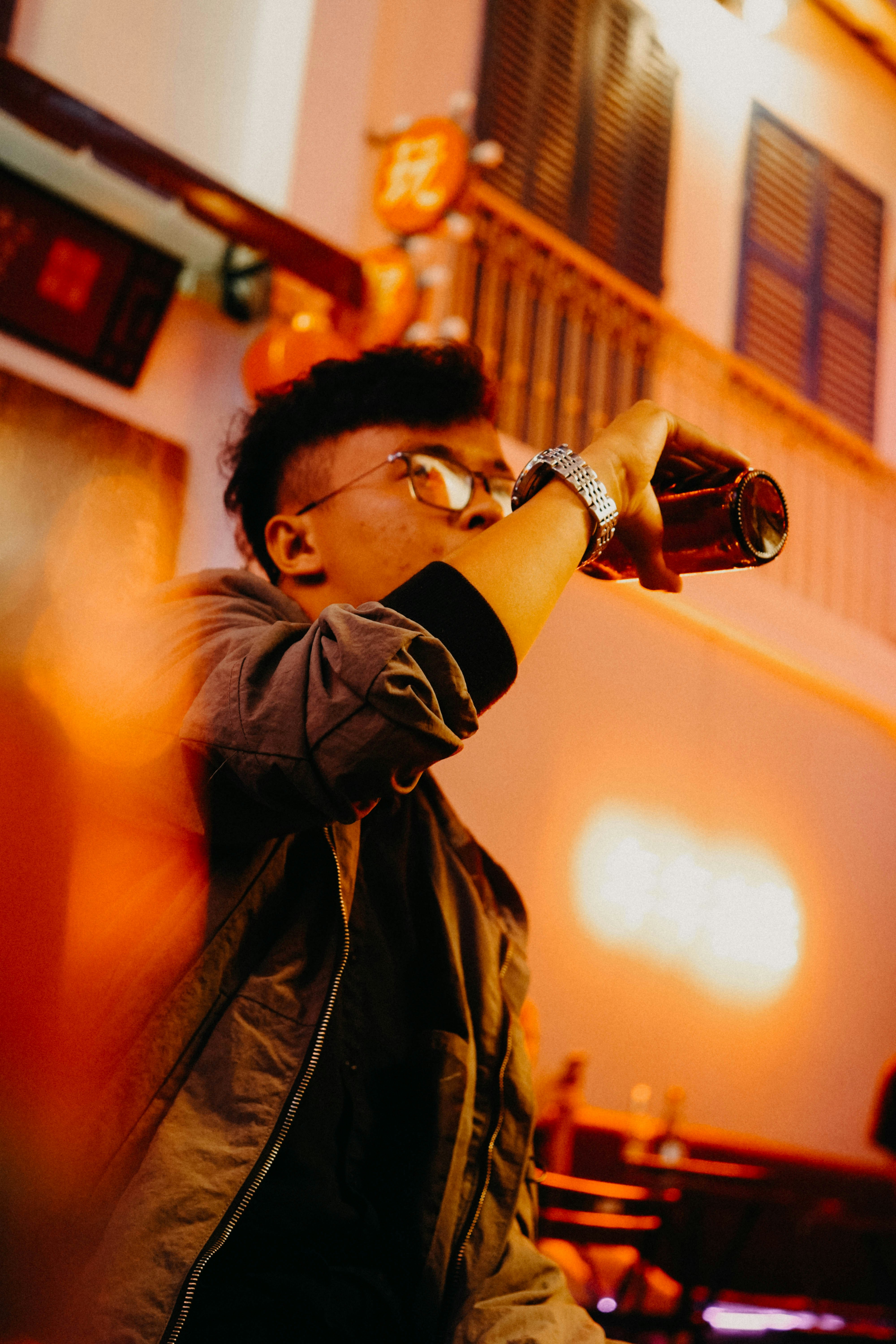 man holding glass bottle