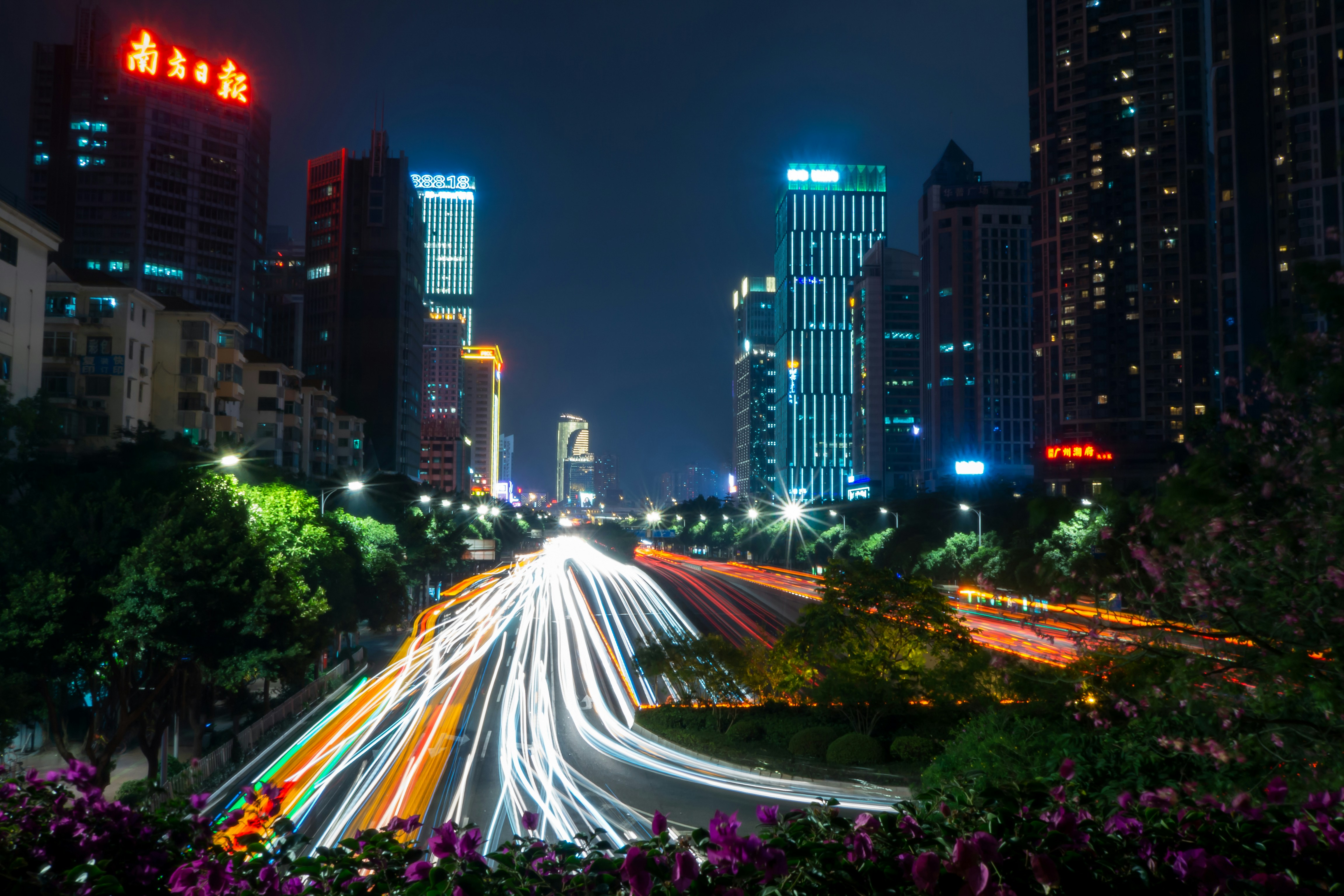 time lapse photography of cars passing by the streets during nighttime
