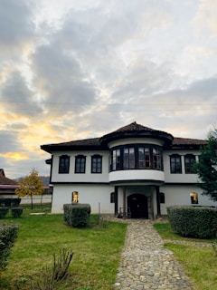Cozy family house facade with garden and blue sky