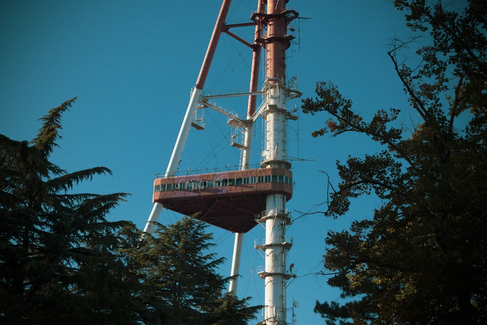 white and brown tower near trees during daytime