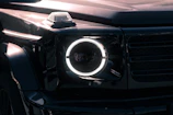 Bright LED headlights glowing on a sleek black SUV.