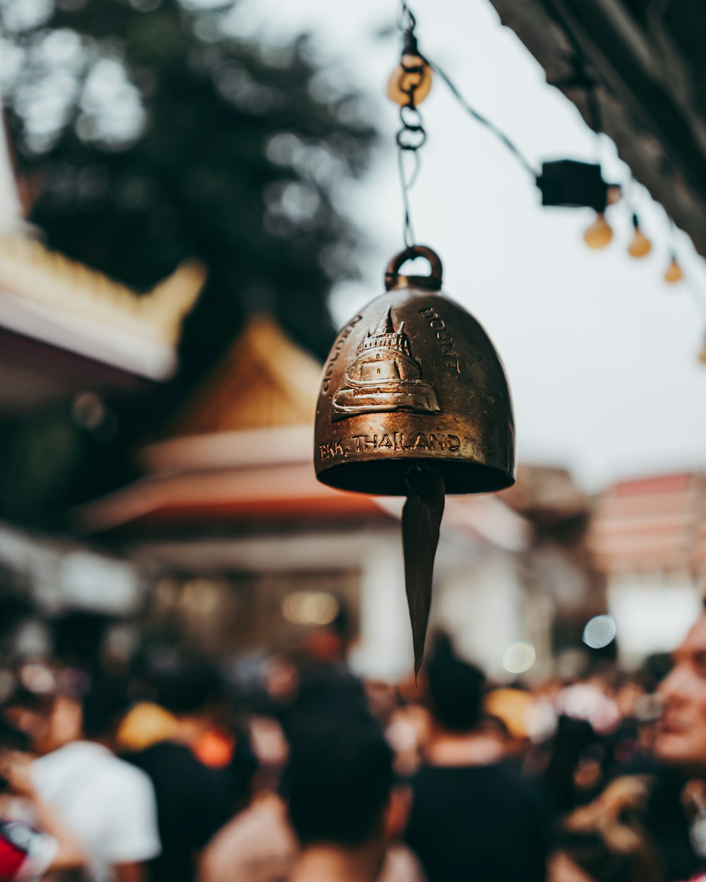 selective focus photography of small brass-colored steel bell