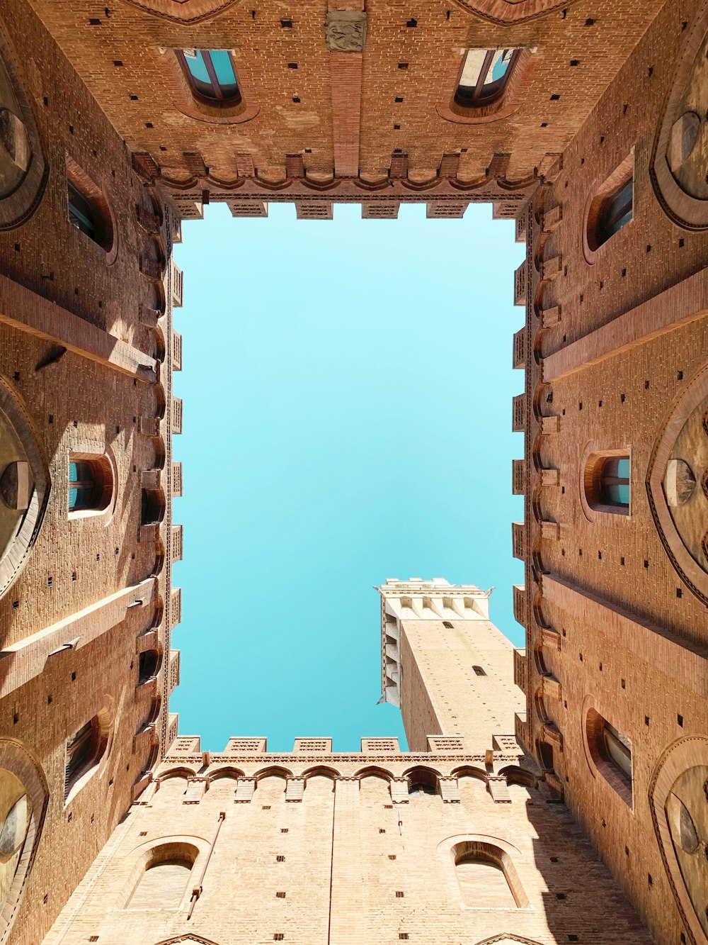 low-angle photography of a brown concrete European building