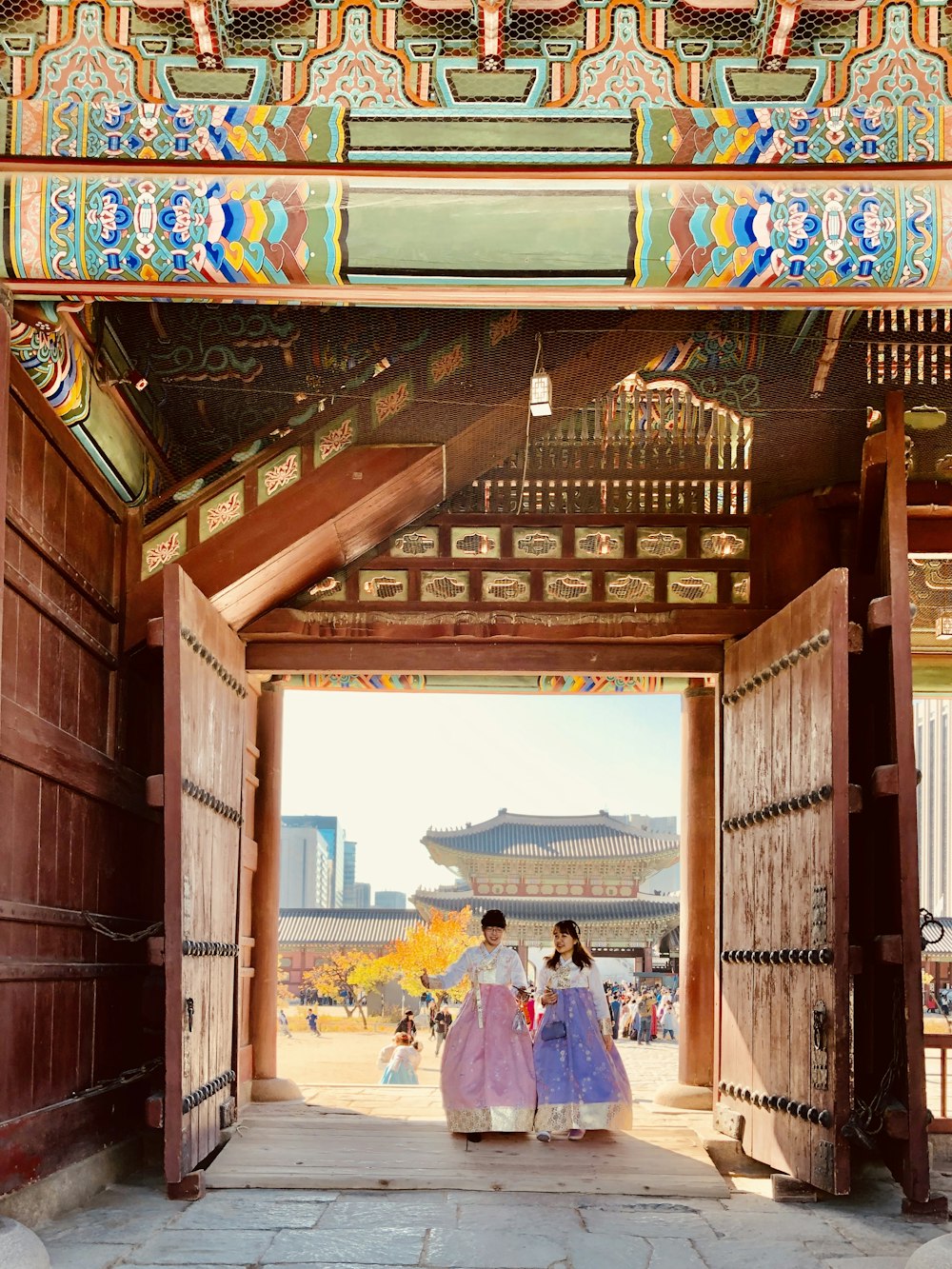 two women standing between gates